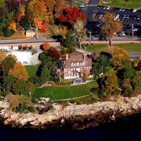 aerial view of misselwood house and rocky coast against the ocean