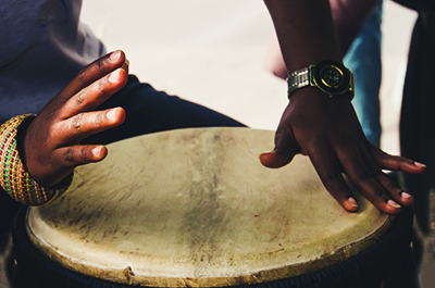Close up image of someone playing a drum
