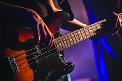 Close up image of someone playing a guitar